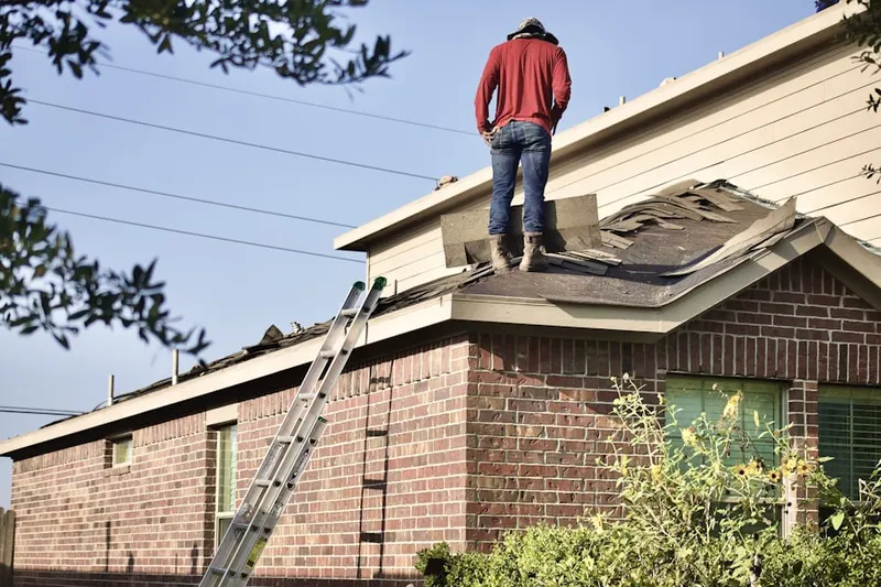 Professional roofer working on a residential roof in East Earl